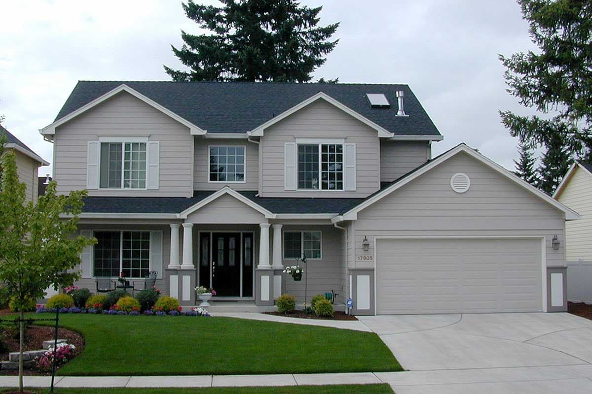 Two-story house plan exterior with gabled dormers, white shutters, covered entry with columns, and an attached two-car garage.