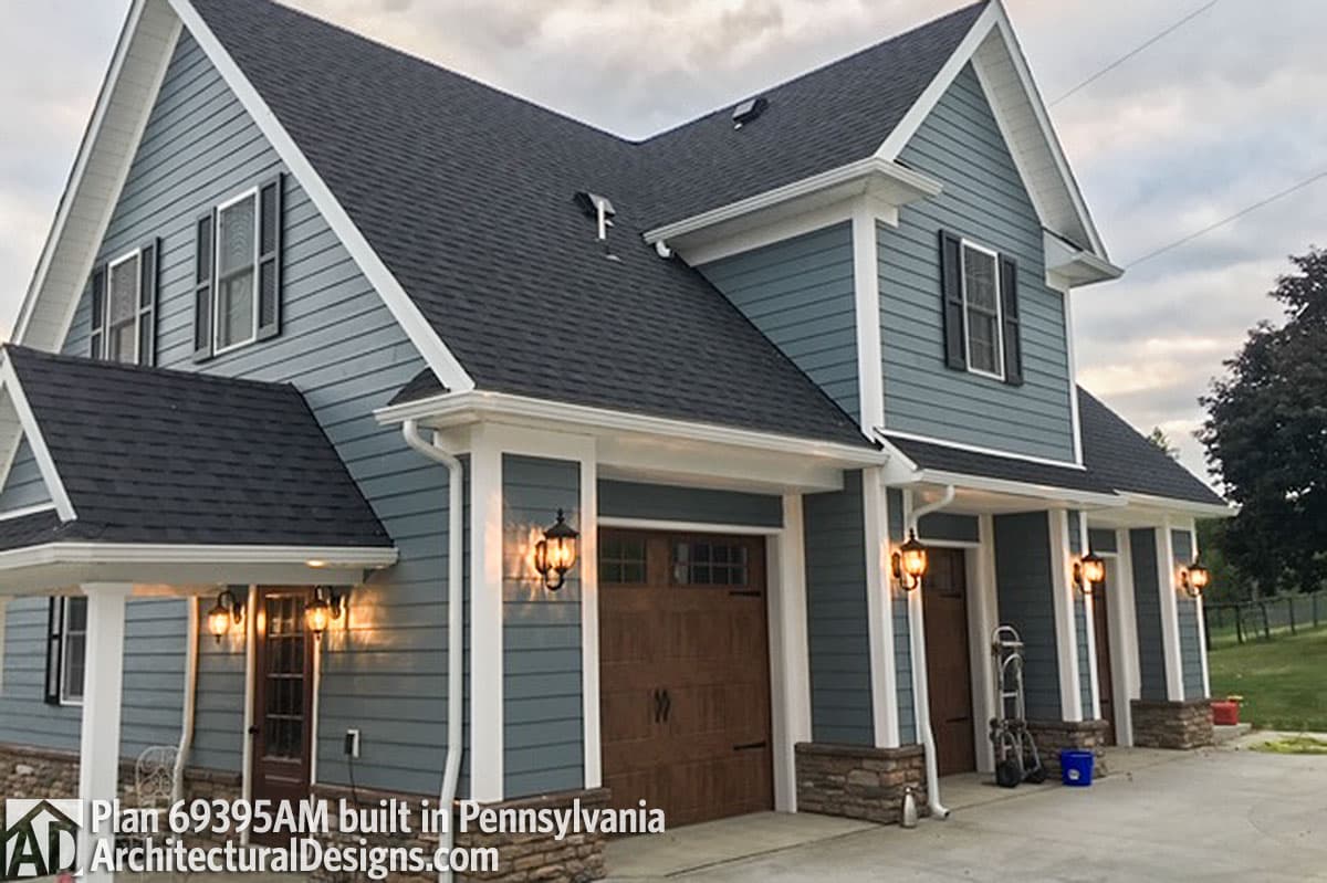 House plan exterior: Two-story Modern Farmhouse with a three-car garage, gabled dormers, stone accents, and a covered entry.