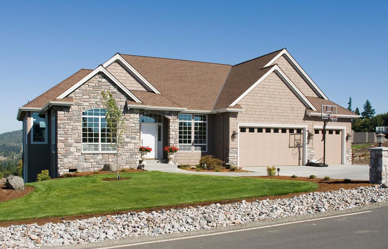 House plan exterior: Modern Farmhouse style, one story, stone front facade, wide garage doors, and prominent gables.