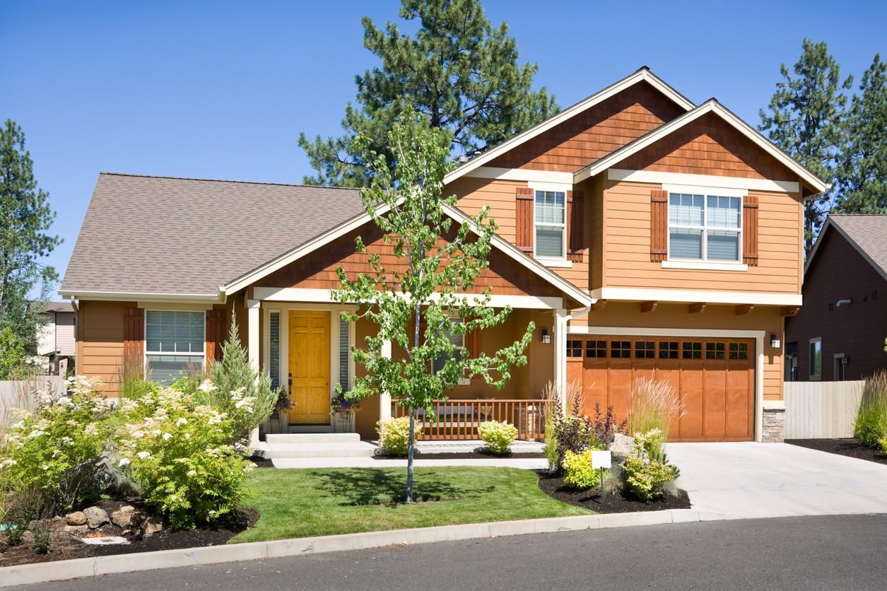 Modern Farmhouse house plan exterior with a covered porch, two stories, wood siding, and a two-car garage.