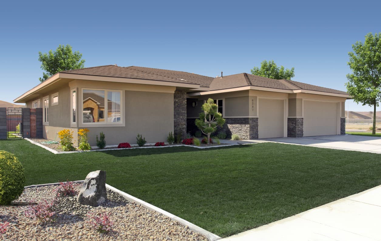 House plan exterior of a single-story ranch-style home with a three-car garage, stone accents, and a covered entrance.