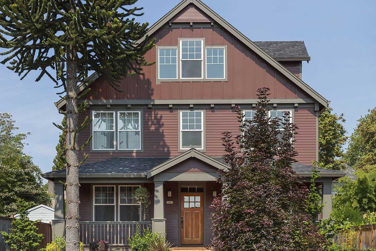 Craftsman style house plan exterior with a gabled roof, covered porch, and multi-pane windows.