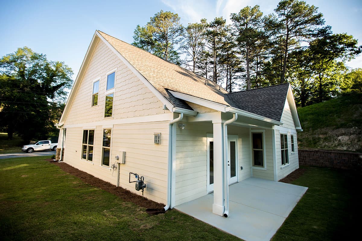 House plan exterior. Modern Ranch style, one story with a covered patio, gable roofline, and stacked windows on front gable.