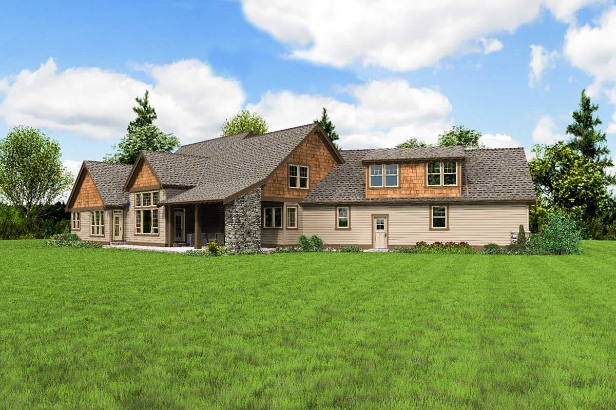 House plan exterior: Two-story home with intersecting gables, stone accents, dormers, and covered porch.
