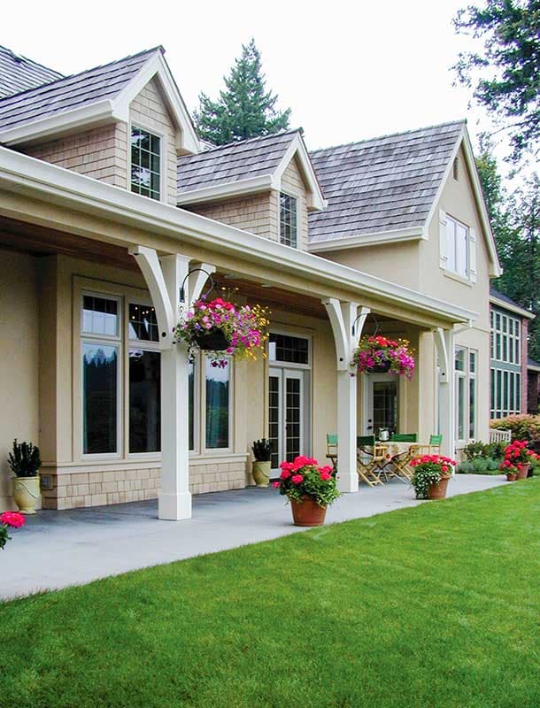 House plan exterior with gabled dormers, covered porch with white columns, and shingled roof.