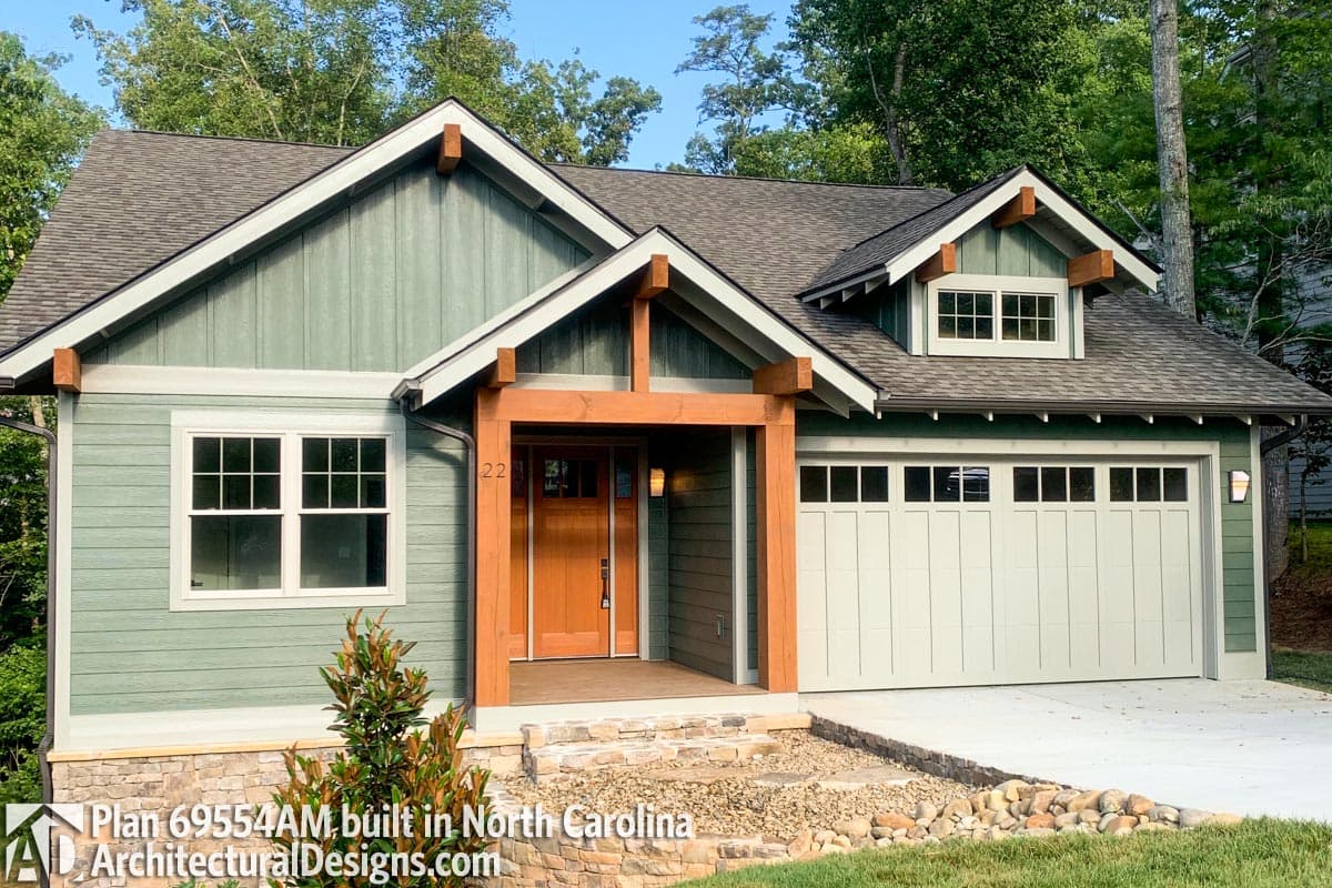 Craftsman style house plan exterior with covered entry, gabled dormer, and side-entry garage.