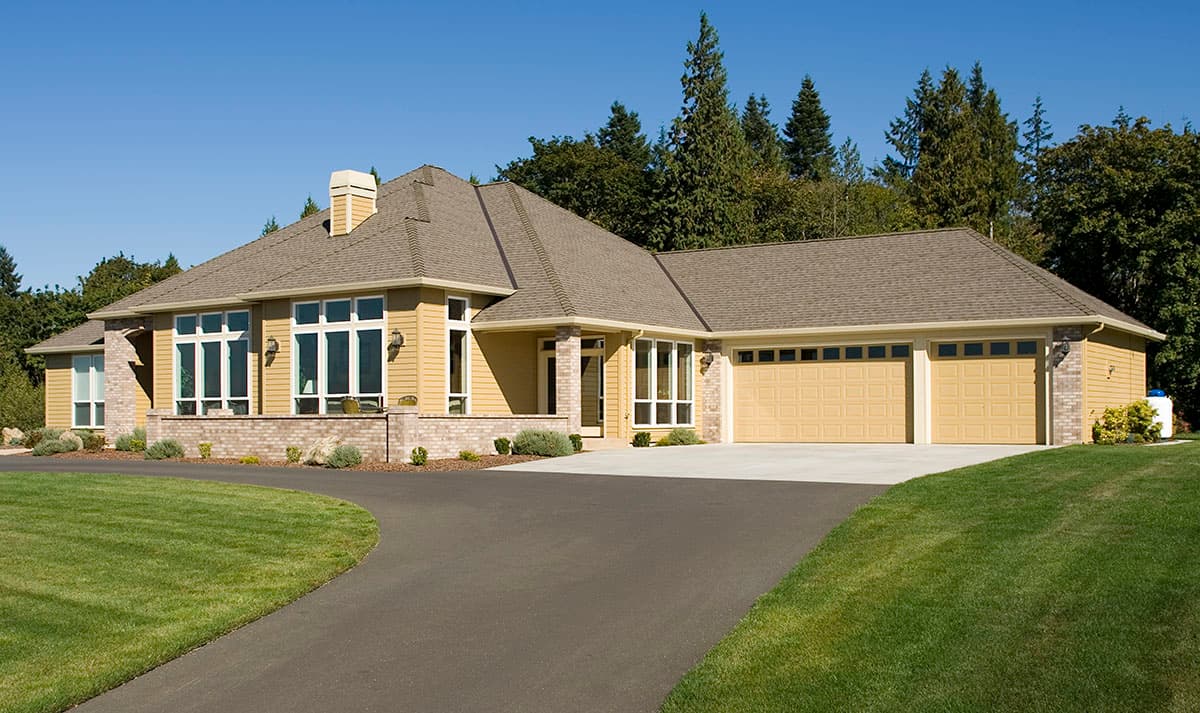 House plan exterior of a one-story home with a hipped roof, prominent gables, and a three-car garage.