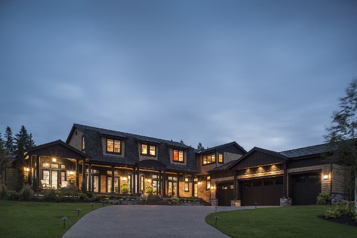 House plan exterior, multi-story home with dormers, covered porch, and attached three-car garage.
