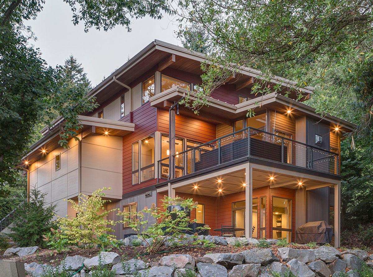Modern house plan exterior with multiple levels, a cantilevered deck, and extensive glazing.