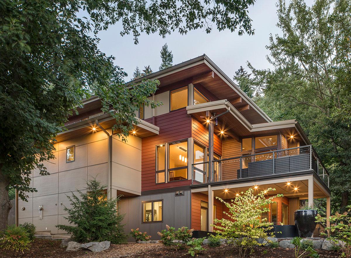 Modern house plan exterior with cantilevered rooflines, varied siding materials, and extensive glazing.