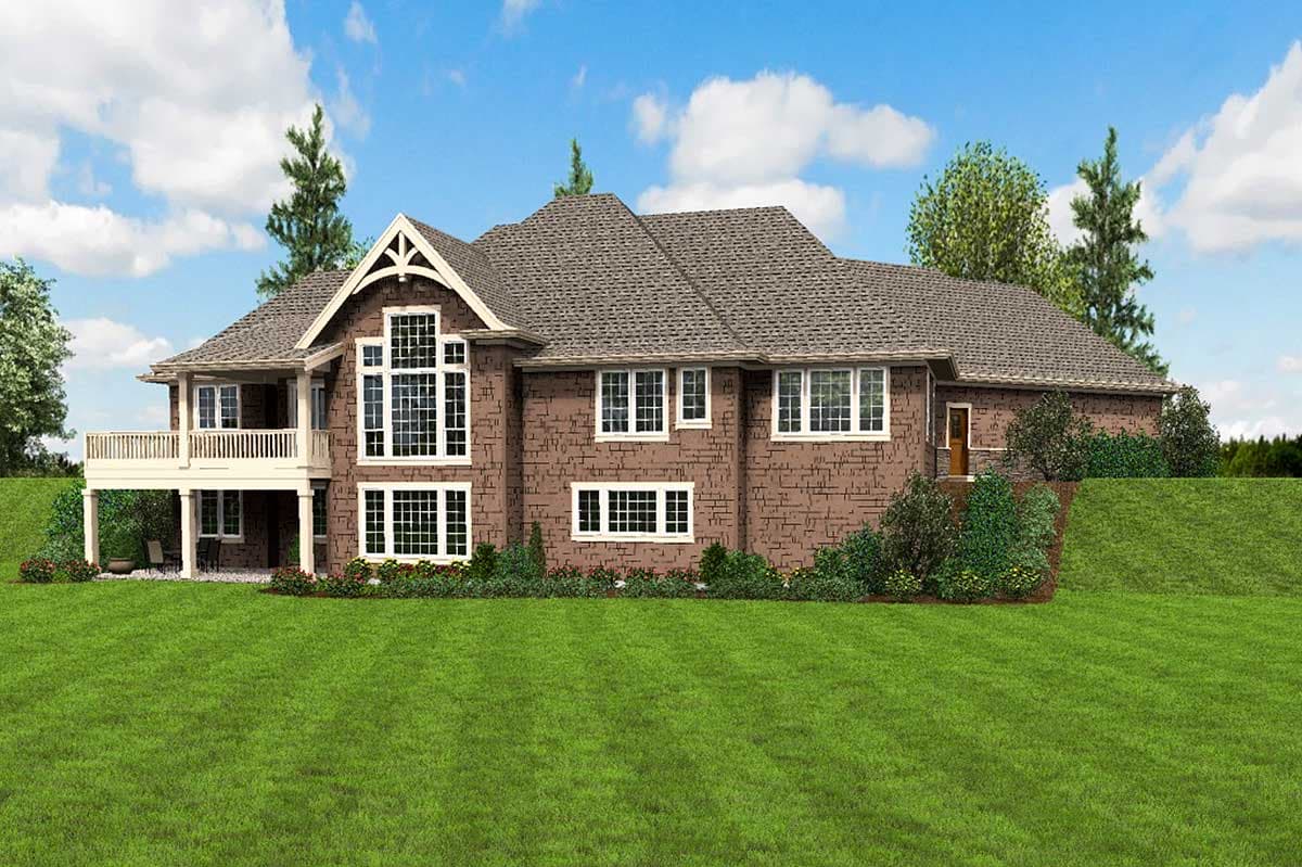 House plan exterior: Two-story brick home with large window groupings, prominent gable with decorative rafter tails, and wraparound porch.
