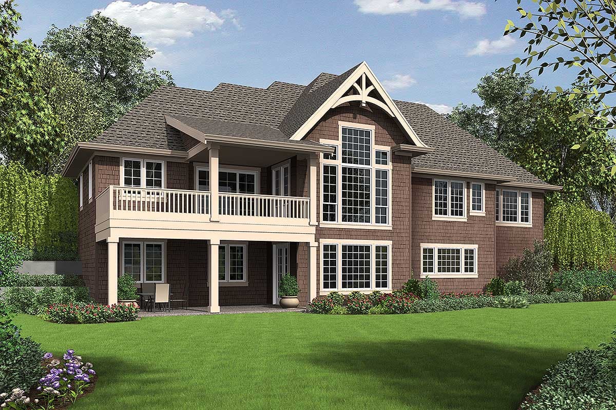 House plan exterior: Two-story traditional home with wraparound deck, prominent gabled dormer, and multi-paned windows.