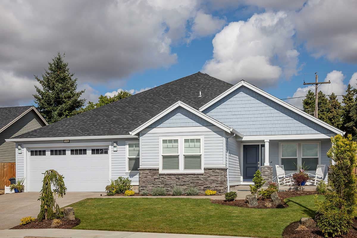 Ranch style house plan exterior with attached two-car garage, covered front porch, gable details, and stacked stone accents.