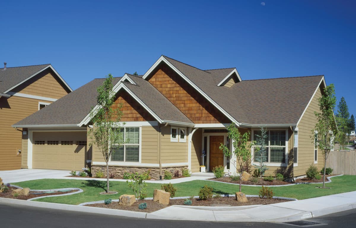 House plan exterior of a one-story home with attached garage, multiple gables, and cedar shake accents.