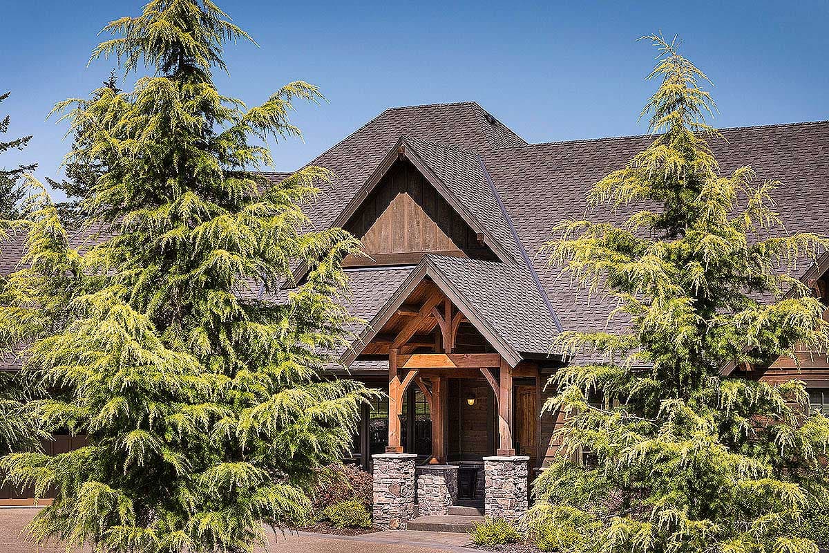 House plan exterior: Gable roof with timber frame porch, stone columns, and wood siding.