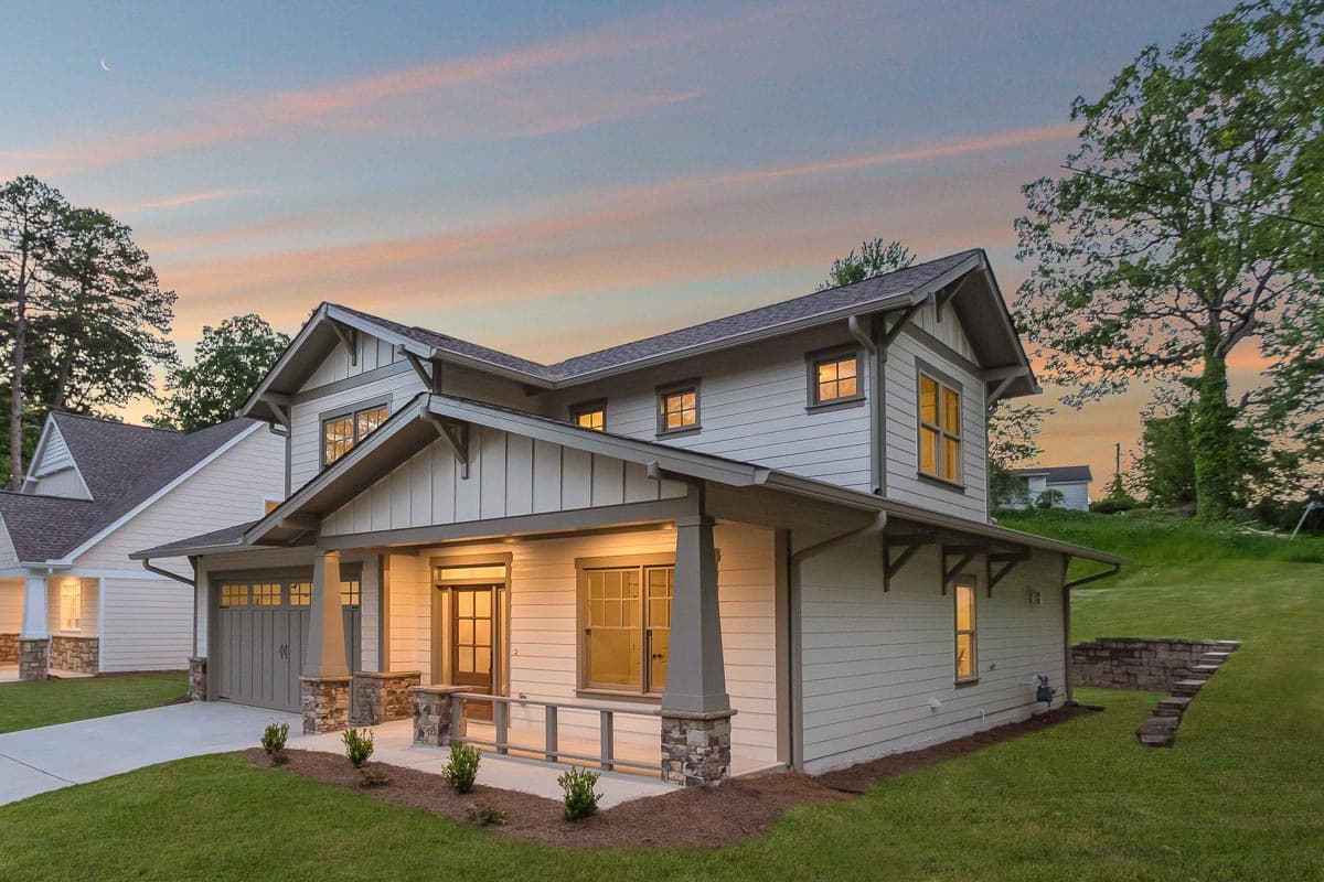 Craftsman style house plan exterior with two stories, covered front porch, gabled roof, and attached garage.