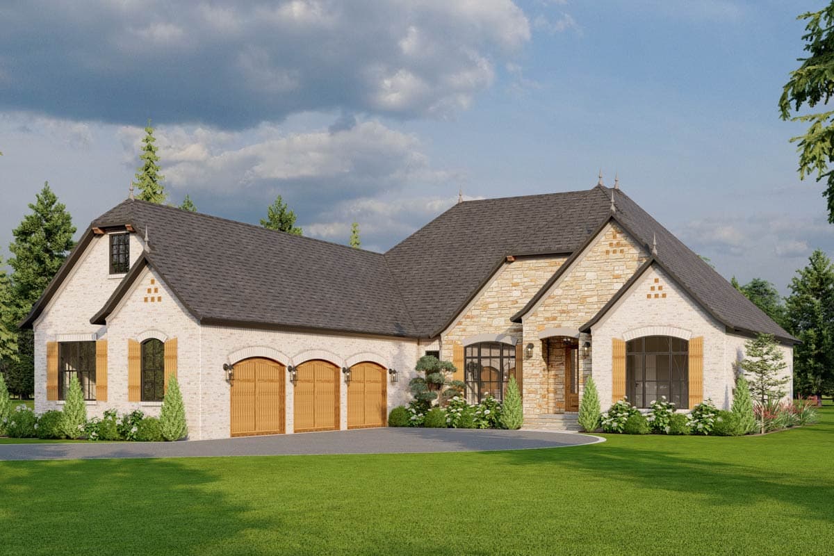 House plan exterior. Two-story French Country style home with stone accents. Features include arched garage doors, dormers, and a prominent roofline.