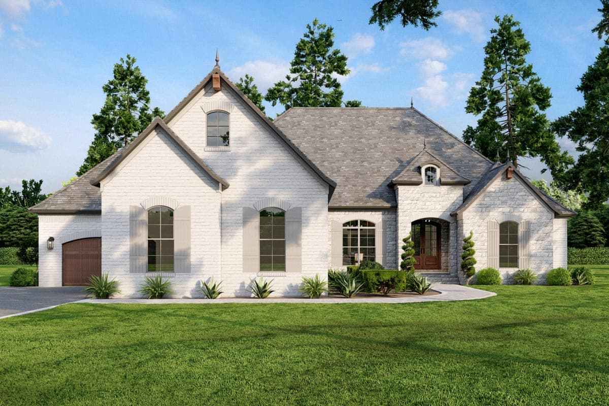House plan exterior. Two-story home with a gabled roof, arched windows, and a side-entry garage. Features include dormers and stone accents.
