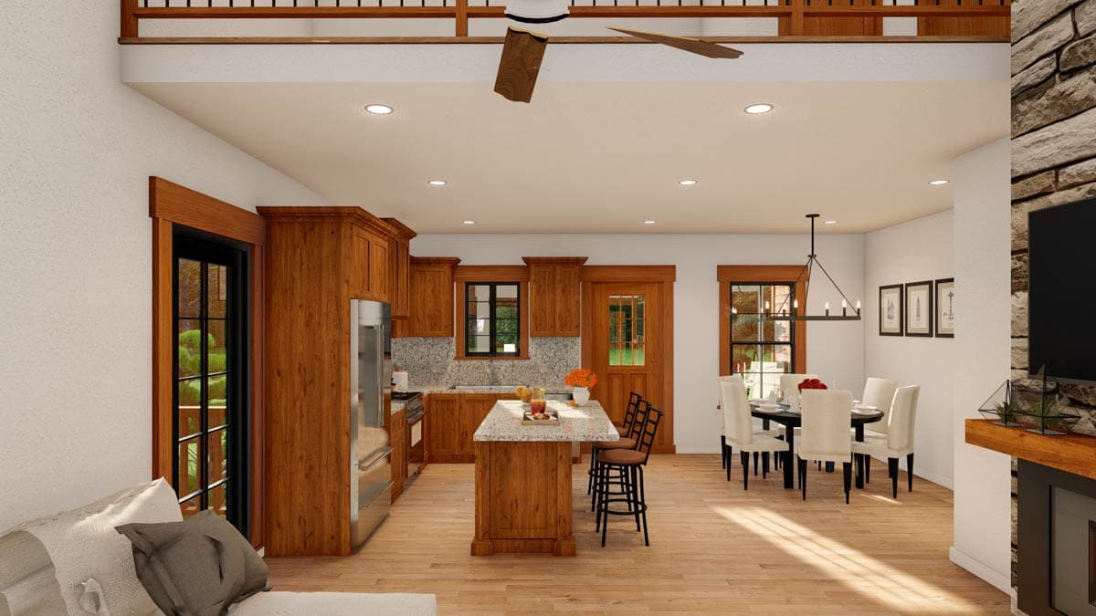 Open concept kitchen with island, dining area, and living space with stone fireplace.