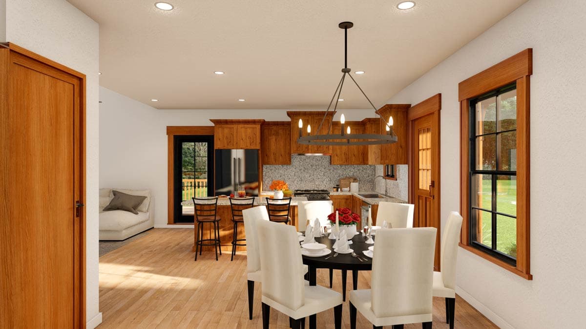 Open concept dining and kitchen with wood cabinetry, granite countertops, island, and dining table.