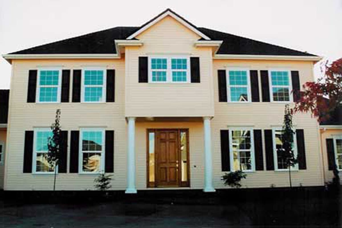 House plan exterior of a two-story home with a central covered entryway, multiple gables, and prominent dormer.