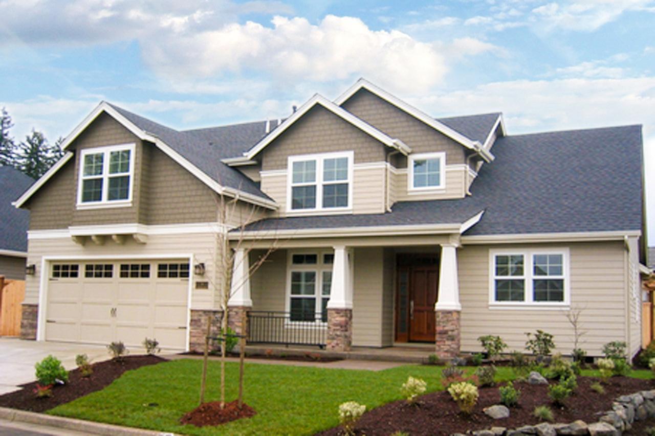 House plan exterior. Two-story Craftsman home with gabled roof, dormers, and a front-entry porch. Attached garage is on the left.