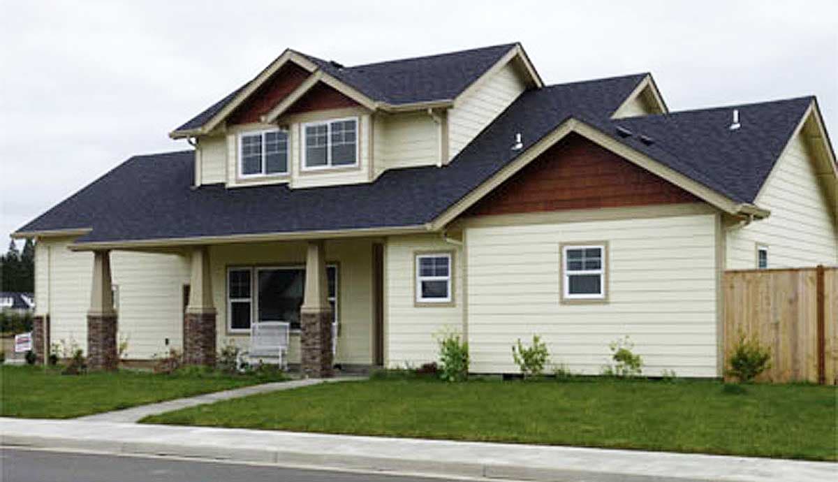 Two-story house plan exterior with a covered entry porch, dormers, multiple gables, and beige siding.