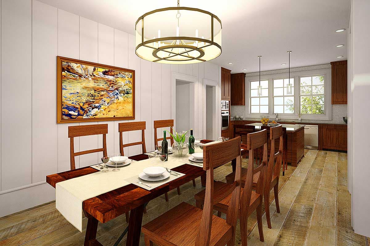 Dining area with wood table and chairs, adjacent to kitchen with wood cabinets and island.