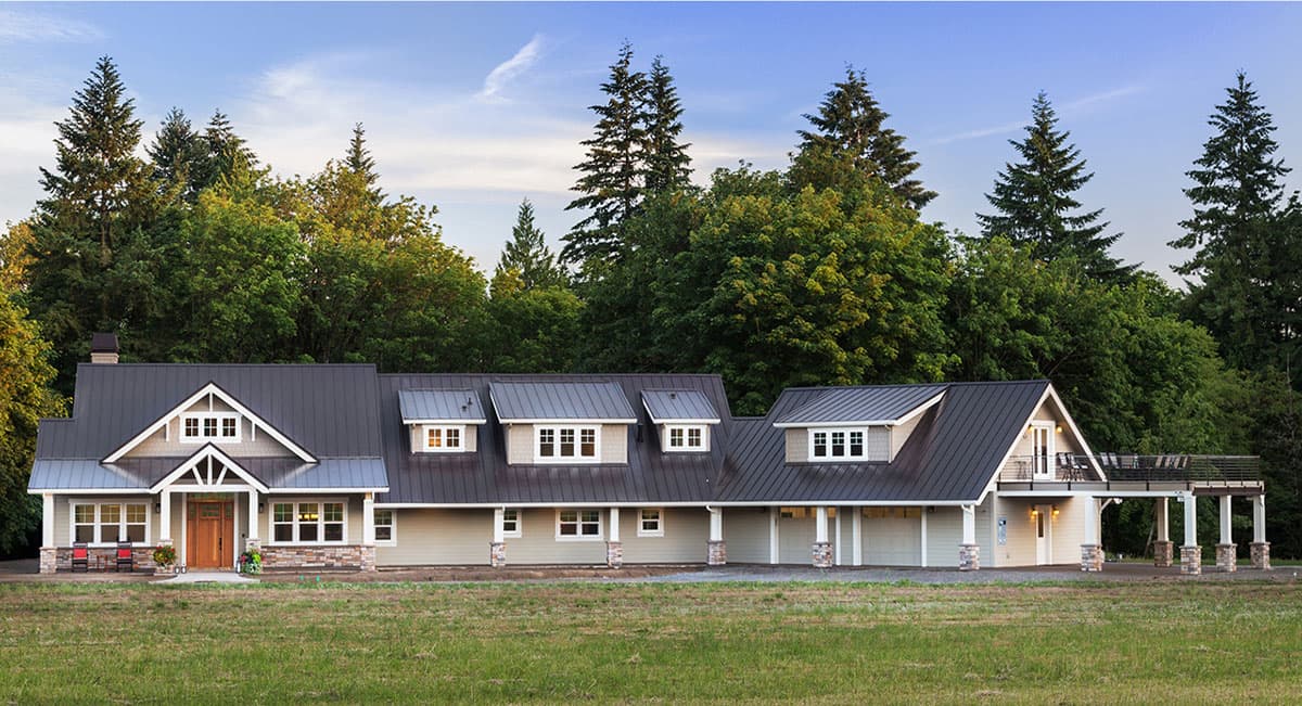 House plan exterior: Ranch style, one story, with a prominent gable entry, dormers, and a covered outdoor living area.