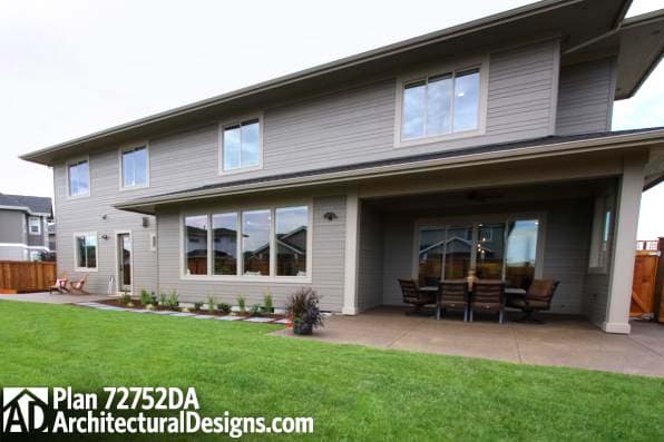 Two-story house plan exterior with covered patio, large windows, and gabled rooflines.