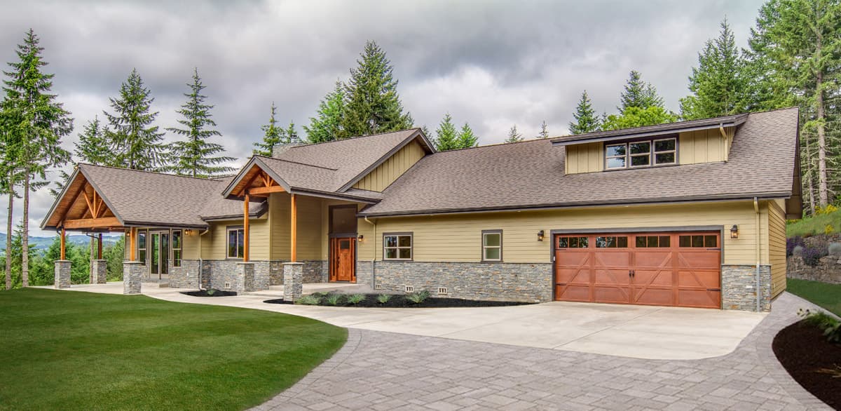 House plan exterior: Two-story Modern Farmhouse with stone accents, covered entryway with exposed beams, and a three-car garage.