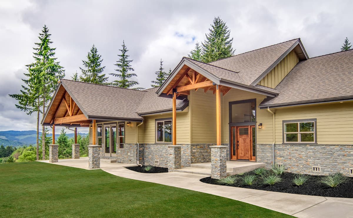 House plan exterior featuring a covered porch with exposed wood beams, stone accents, and multiple gables.