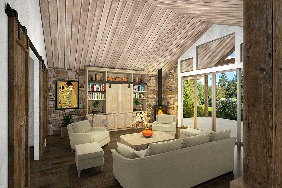 Great room with vaulted wood-paneled ceiling, stone fireplace, built-in shelves, barn doors, and large glass doors.