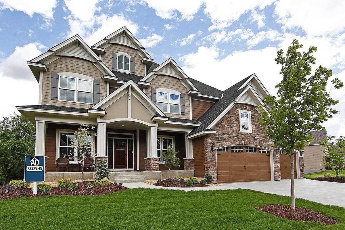 House plan exterior with stone accents, covered entry porch, dormers, and a three-car garage.