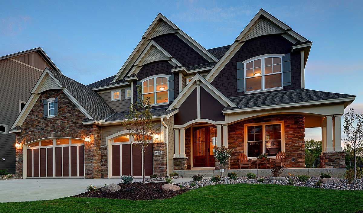 House plan exterior: two-story home with stone and shingle siding, multiple gables, arched garage doors, and covered front porch.