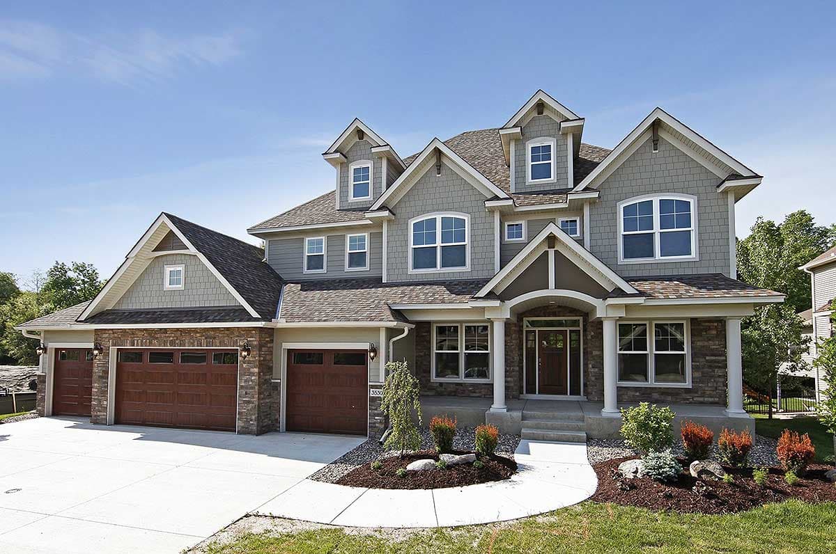House plan exterior. Two-story home with Craftsman style. Features include multiple gables, front entry porch, and three-car garage.
