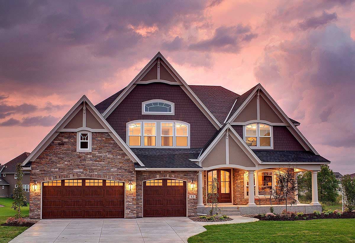 House plan exterior showing a two-story home with stone accents, three gables, a covered porch, and a three-car garage.