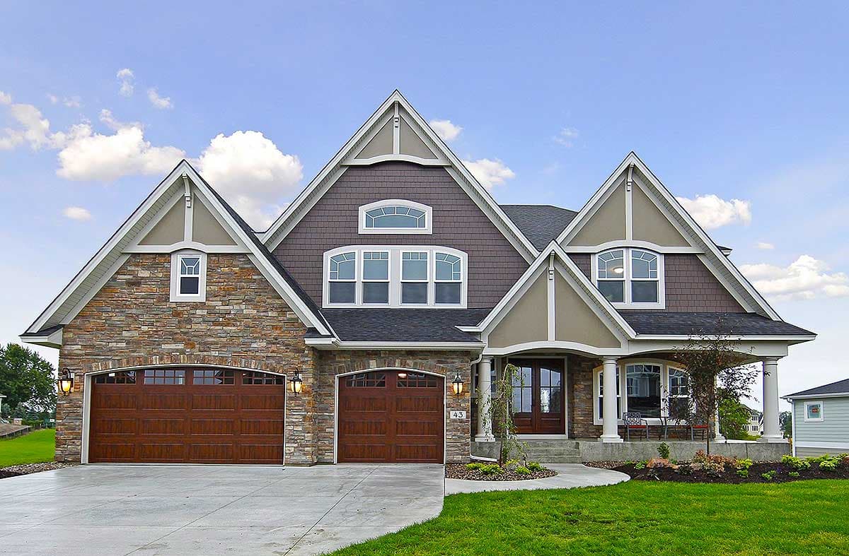 House plan exterior: Two-story Modern Farmhouse with stone accents, large gables, and a covered front porch with columns.
