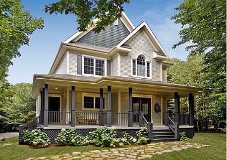 House plan exterior: Two-story home with a wraparound porch, gables, dormers, and arched window.