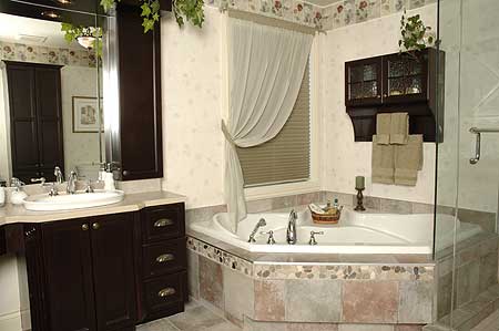 Bathroom with corner jacuzzi tub, vanity with dark cabinetry and double sink, and glass-enclosed shower.