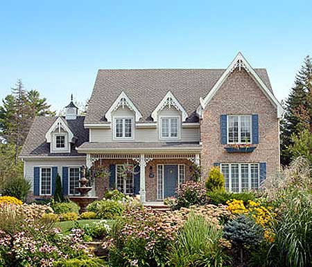 House plan exterior featuring a brick facade, dormers, decorative gables, and a covered front porch.