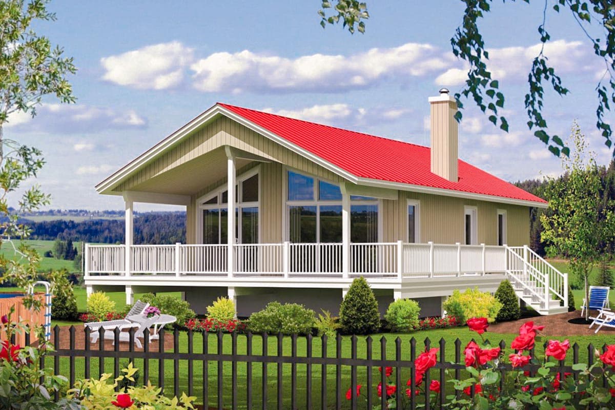 House plan exterior: Single-story home with a red metal roof, covered porch, extensive decking, and a prominent chimney.