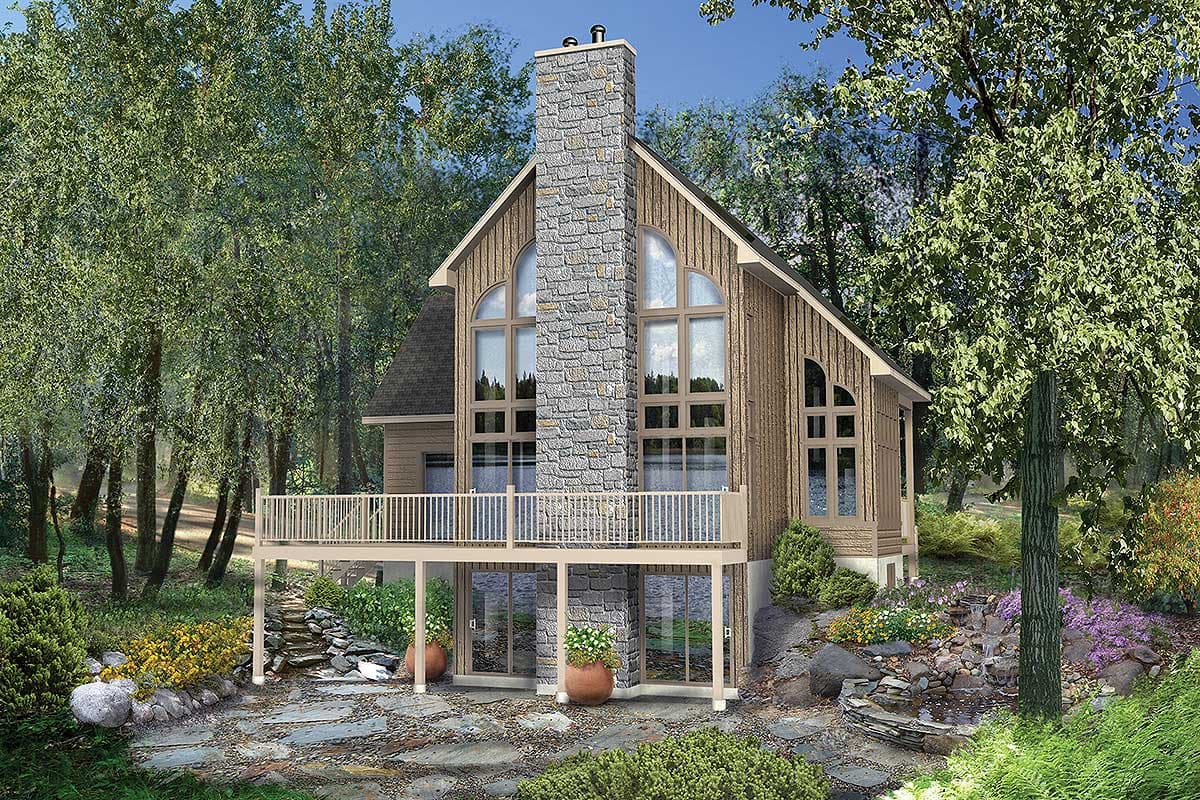 House plan exterior: A two-story cabin with a prominent stone chimney, expansive arched windows, and a wraparound deck.