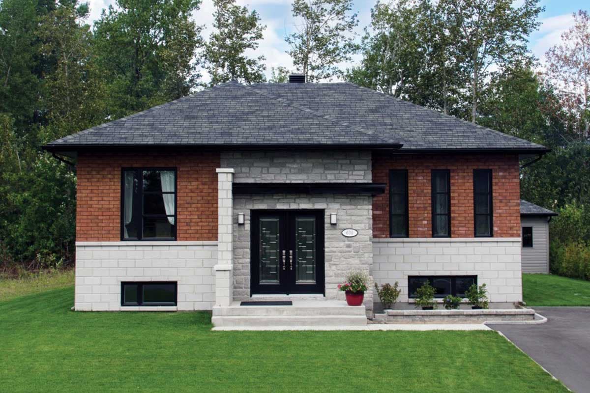 House plan exterior: Two-story modern home with brick facade, stone accents, hip roof, and double front doors.