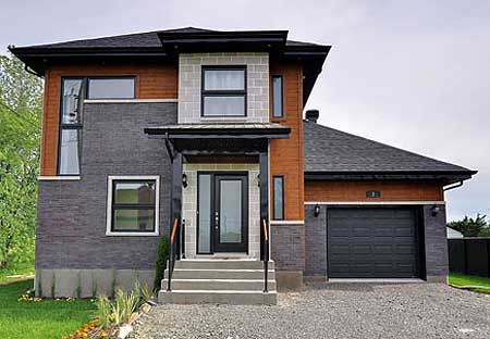 House plan exterior: two-story modern home with stone and wood facade, attached garage, and peaked roofline.