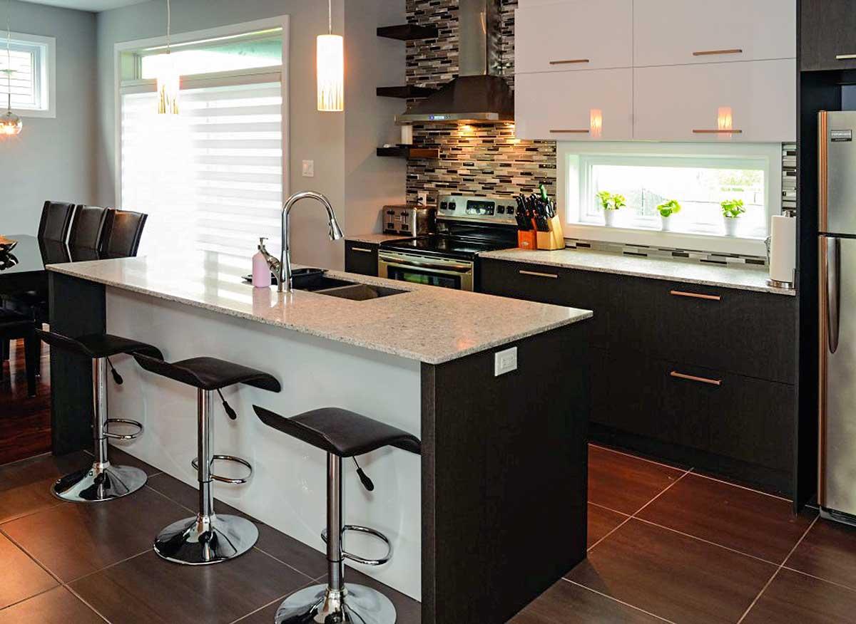 Modern kitchen with large island, granite countertops, stainless steel appliances, mosaic backsplash, and pendant lighting.