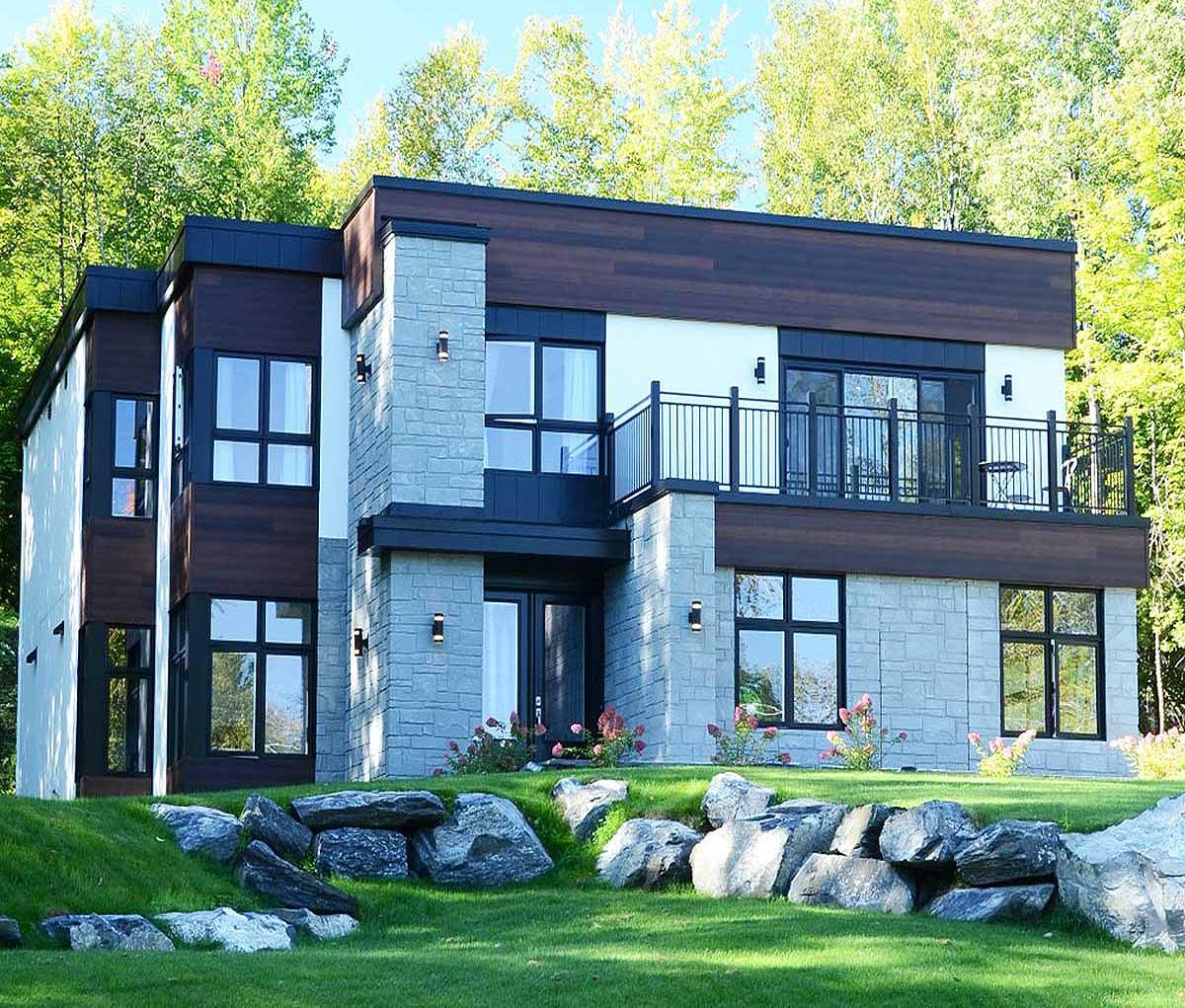 Modern house plan exterior with stone and wood facade, multiple windows, and balcony.