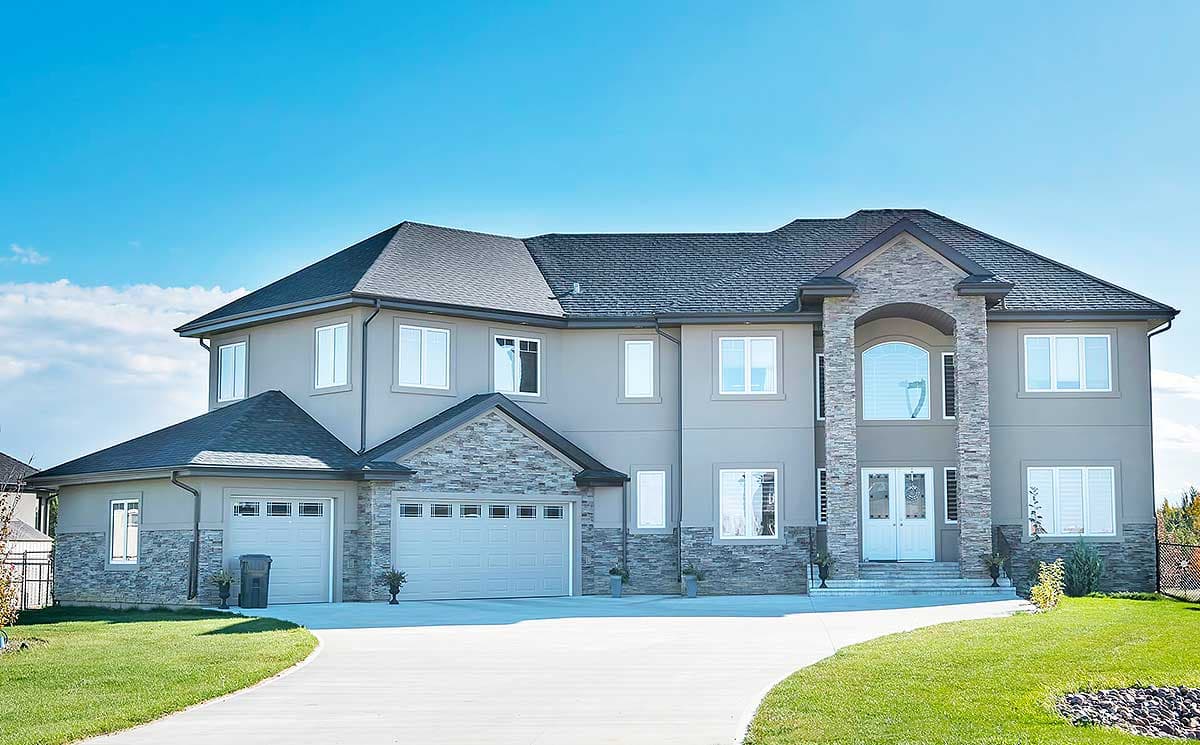 Two-story house plan exterior with stone accents, a double garage, arched entryway, and multiple gables.