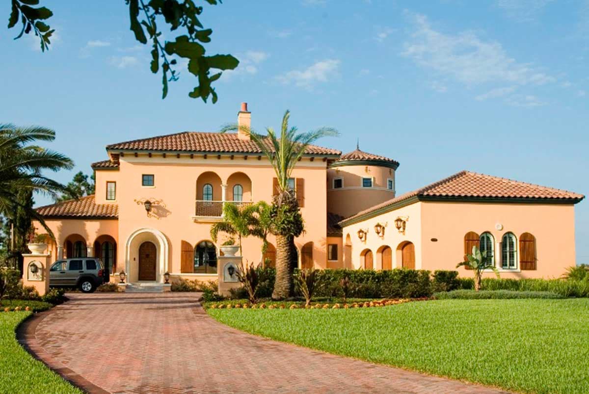 House plan exterior: two-story Italian Renaissance style with arched windows, balcony, and terracotta roof tiles.