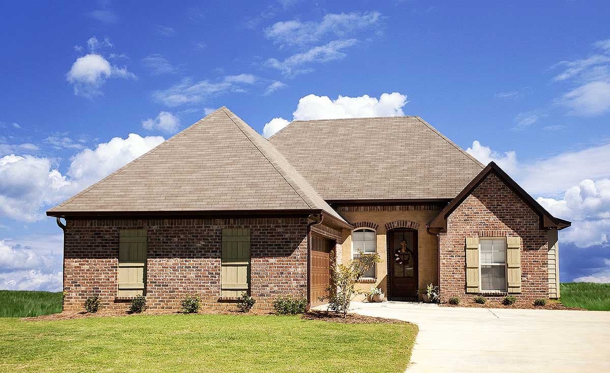 House plan exterior: One-story brick and stucco home with a prominent gable, attached garage, arched windows, and shutters.